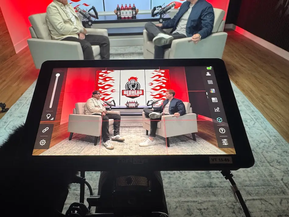 Camera monitor showing an interview being filmed for social content